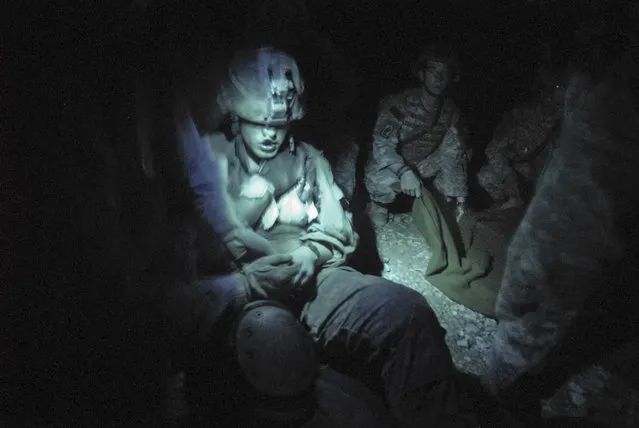 A soldier is treated after being shot in the chest during an ambush. Another soldier was killed during the same ambush. In the wars in Iraq and Afghanistan, army medics and doctors saved an unprecedented 90% of wounded soldiers. (Photo and caption by Van Agtmael/Harrison Jacobs/Magnum Photos)