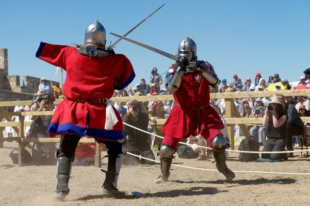 A Knight from England, left, battles a knight from Poland during the International Medieval Combat at the castle of Belmonte, May 4, 2014, in Belmonte, Spain. (Photo by Juan Naharro Gimenez/Getty Images)