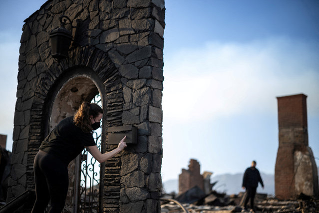 Kelly Kirshner looks at the mailbox of the house where she grew up and where her mother used to live, after it was destroyed by the Palisades Fire, on January 11, 2025. (Photo by Carlos Barria/Reuters)