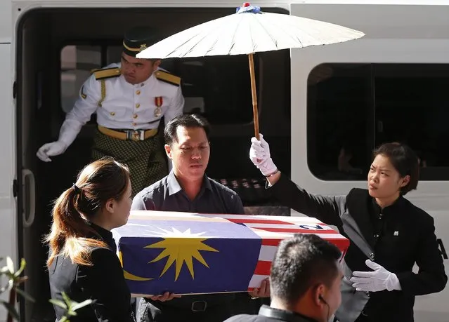 Lt Lee Vee Weng (C) carries the remains of his one-year-old son Benjamin Lee Jian Han, who was killed in the MH17 crash, into the Xiao En Bereavement Centre in Kuala Lumpur September 9, 2014. Malaysia Airlines (MAS) Flight MH17 crashed after being shot down over war-torn Ukraine on July 17, killing all 298 people on board. (Photo by Olivia Harris/Reuters)