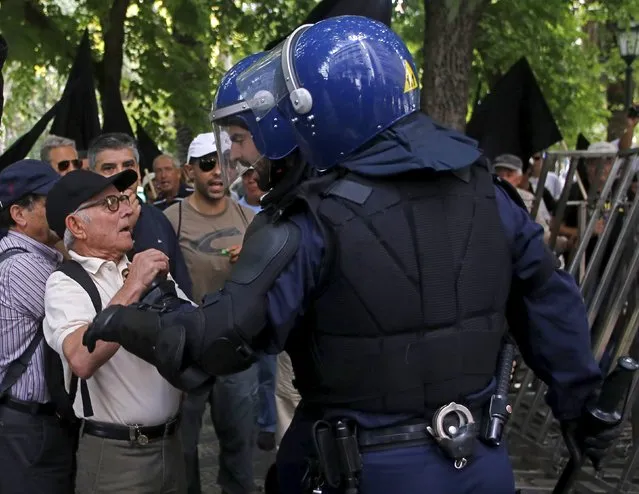 Police clash with protesters demanding payback of investments they had made in the Espirito Santo Group, which owned Banco Espirito Santo (BES), in front of the bank's headquarters in Lisbon, Portugal, September 9, 2015. The state in August 2014 rescued Portugal's second largest lender by injecting 4.9 billion euros into the “good bank” Novo Banco, and keeping the toxic assets at the “bad bank” BES. (Photo by Hugo Correia/Reuters)