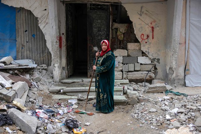 Shahira Sammour, 49, poses in front of her destroyed home in Jabalia, northern Gaza Strip, on February 9, 2025. Israel's military offensive in response to Hamas's October 7,2023, attack has left much of Gaza in ruins, including schools, hospitals and most civil infrastructure. Human Rights Watch said the destruction of Gaza “reflects a calculated Israeli policy to make parts of the strip unlivable”. Last week, US President Donald Trump floated the idea of US administration over Gaza, envisioning rebuilding the devastated territory into the "Riviera of the Middle East" after resettling Palestinians elsewhere, namely Egypt and Jordan. The remarks have prompted global backlash, and Arab countries have firmly rejected the proposal, insisting on a two-state solution with an independent Palestinian state alongside Israel. (Photo by Bashar Taleb/AFP Photo)