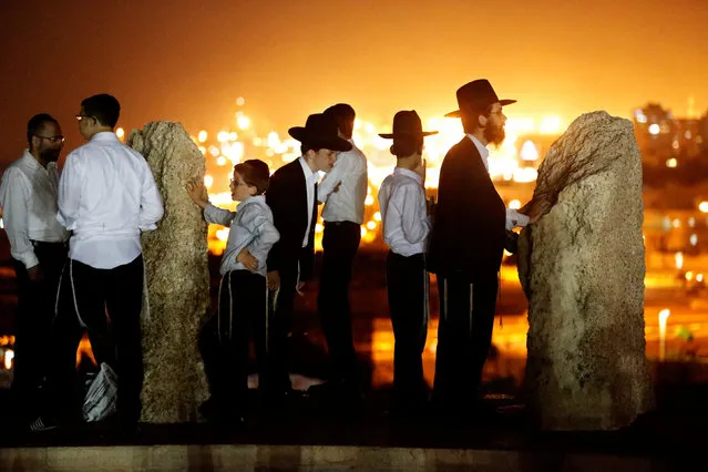 Ultra-Orthodox Jews pray during their vacation in the late summer season when there is a break in their religious study obligations, in Ashdod, southern Israel August 16, 2016. (Photo by Amir Cohen/Reuters)