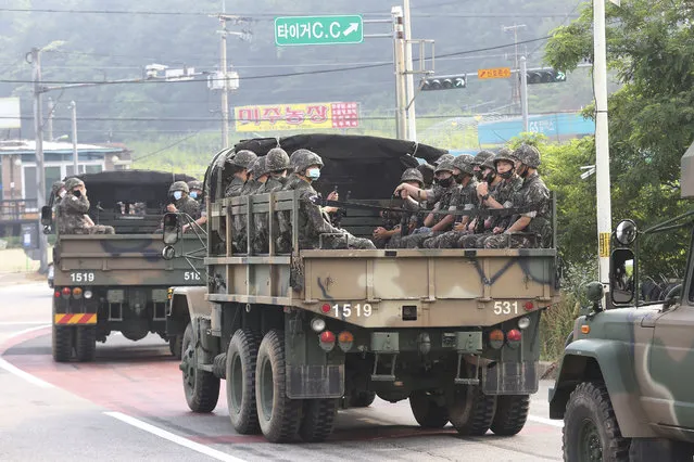 South Korean army soldiers ride on the back of trucks in Paju, near the border with North Korea, South Korea, Wednesday, June 17, 2020. (Photo by Ahn Young-joon/AP Photo)