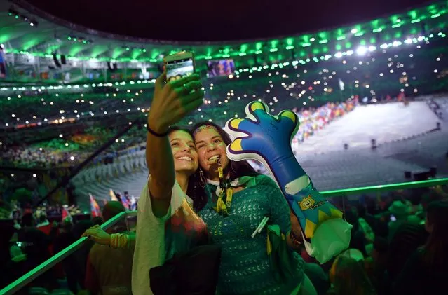 Scenes from the closing ceremony for the 2016 Rio Olympics, Rio de Janeiro, August 21, 2016. Spectators taking a selfie. (Photo by Ed Jones/AFP Photo)