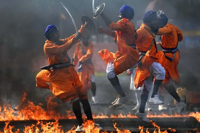 Cadets of the Sikh Regimental Center perform Gatka martial stunts during a combined display ahead of a graduation ceremony at the Officers Training Academy, in Chennai on October 28, 2022. (Photo by Arun Sankar/AFP Photo)