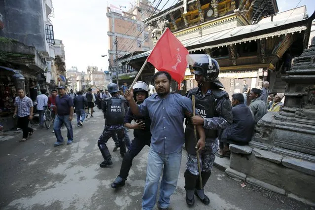 Nepalese riot police personnel detain an opposition supporter protesting against the proposed constitution during a nationwide strike called by the opposition parties in Kathmandu, Nepal September 20, 2015. Nepal will adopt its first full democratic charter on Sunday, a historic step for a nation that has seen war, a palace massacre and devastating earthquakes since a campaign to create a modern state began more than 65 years ago. (Photo by Navesh Chitrakar/Reuters)