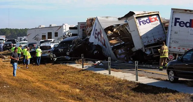 Cars and trucks are piled on Interstate 10 in Southeast Texas, November 22, 2012.  The Texas Department of Public Safety says at least 35 people have been injured in a more than 50-vehicle pileup.  (Photo by Guiseppe Barranco/The Beaumont Enterprise)