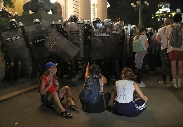 Riot police stand in formation as demonstrators gather during an anti-government protest amid the spread of the coronavirus disease (COVID-19), outside the parliament building in Belgrade, Serbia, July 10, 2020. (Photo by Marko Djurica/Reuters)
