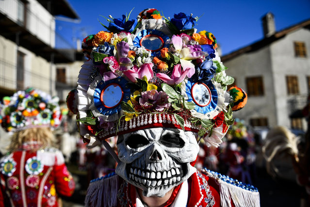 Man dressed in colorful clothes and wearing scary wooden masks decorated with mirrors during the Napoleon-themed Coumba Freida Carnival on January 27, 2024 in Doues near Aosta, Italy. The typical costumes of this carnival recall the passage of the soldiers following Napoleon in May 1800. (Photo by Stefano Guidi/Getty Images)