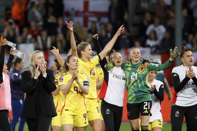 Belgium's coach Elisabet Gunnarsdottir, team captain Tessa Wullaert, Justine Vanhaevermaet and goalkeeper Lisa Lichtfus, from left, celebrate after defeating England 3-2 in their Women's Nations League soccer match at Den Dreef Stadium in Leuven, Belgium, Tuesday, April 8, 2025. (Photo by Omar Havana/AP Photo)