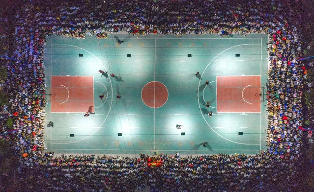 Aerial view of villagers watching a basketball match at Yangping Village on July 12, 2020 in Yuncheng, Shanxi Province of China. (Photo by Shi Yunping/VCG via Getty Images)