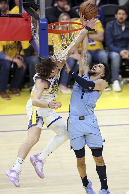 Golden State Warriors' Brandin Podziemski, left, blocks a dunk attempt by Memphis Grizzlies' Scotty Pippen Jr. during the second half of an NBA play-in tournament basketball game in San Francisco, Tuesday, April 15, 2025. (Photo by Scott Strazzante/San Francisco Chronicle via AP Photo)