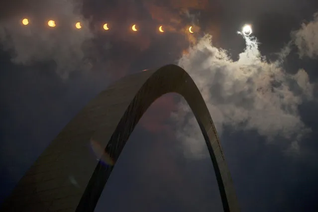 In this multiple exposure photograph, the phases of a partial solar eclipse are seen over the Gateway Arch in St. Louis on August 21, 2017.(Photo by Jeff Roberson/AP Photo)