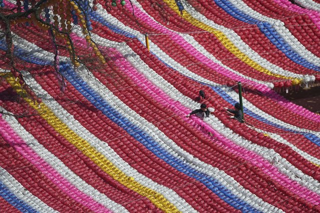 Workers adjust the lanterns in preparation ahead of Buddha's birthday celebrations on May 5, at Jogye temple in Seoul, South Korea, Friday, March 28, 2025. (Photo by Lee Jin-man/AP Photo)