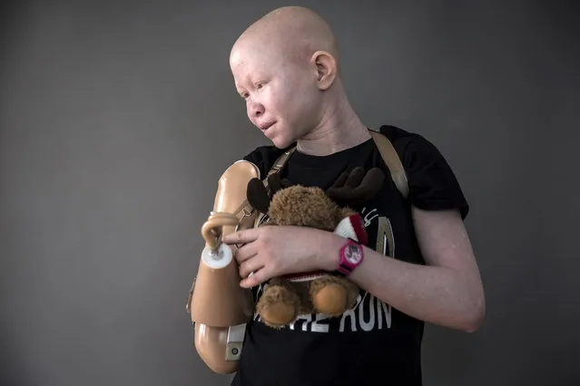 15-year-old Pendo Sengerema from Tanzania poses for a portrait with a stuffed animal she says she sleeps with at night to make her feel safe. (Photo by Carlo Allegri/Reuters)