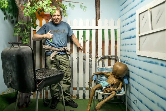 Chris has fun with one of the exhibits. (Photo by Chris Burton/Caters News Agency)