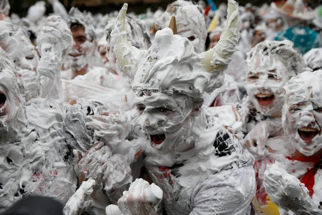 Students from St Andrews University are covered in foam as they take part in the traditional “Raisin Weekend” in the Lower College Lawn, at St Andrews in Scotland, Britain October 23, 2017. The weekend, which begins on Sunday, involves rituals for new students, culminating in a foam fight on Monday morning. (Photo by Russell Cheyne/Reuters)