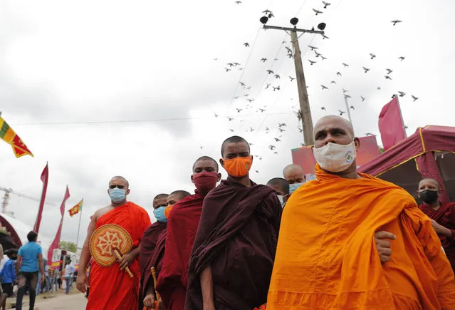 Sri Lankan Buddhist monks supporting prime minister Mahinda Rajapaksa attend an election rally in Colombo, Sri Lanka, July 28, 2020. Sri Lanka’s powerful, popular Rajapaksa brothers are likely to get strong support in parliamentary elections Wednesday that could add to their family political dynasty and their ability to amend the constitution. The prospect of those changes raise fears of weakening government institutions and the rule of law. The results of the vote could also lead to sibling rivalry, charting the country into more confusion, analysts say. (Photo by Eranga Jayawardena/AP Photo)