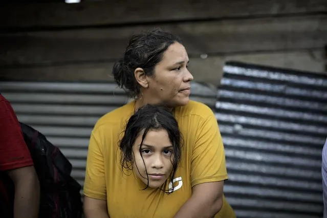 Kaoly Becerra, a 40-year-old Venezuelan migrant, hugs her 8-year-old daughter, Ambar Castillo,  in the town of Bajo Chiquito, Panama, 13 October 2022. Bajo Chiquito is the first Panamanian town where irregular migrants arrive after crossing the Darién Gap, the dangerous border that divides Panama and Colombia. The Darién jungle is considered one of the most dangerous migratory routes in the world, both because of its wild environment and because of the presence of armed groups and organized crime that have used it for decades to illegally traffic drugs, weapons and people. (Photo by Bienvenido Velasco/EPA/EFE)