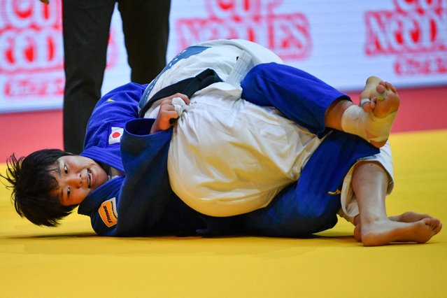 Japan's Haruka Kaju (blue) competes against China's Jing Tang in the women's -63kgs qualification round of the Judo World Championships at the Papp Laszlo Arena in Budapest, Hungary, on June 16, 2025. (Photo by Ferenc Isza/AFP Photo)
