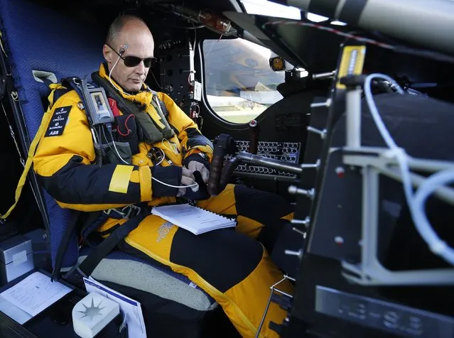 Swiss pilot Bertrand Piccard prepares for a test flight of the solar-powered Solar Impulse 2 experimental aircraft in Payerne November 13, 2014. (Photo by Ruben Sprich/Reuters)