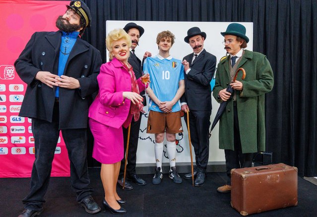 Staff and people in costumes of main characters from the Adventures of Tintin pose with the new Belgium away kit at a press conference in Louvain-la-Neuve, Belgium, 14 March 2024. The team's new home and away jerseys, based on the Adventures of Tintin world-famous comic book series created by Herge, were presented at the event and the squad for the upcoming two friendly matches was announced. (Photo by Olivier Matthys/EPA/EFE)