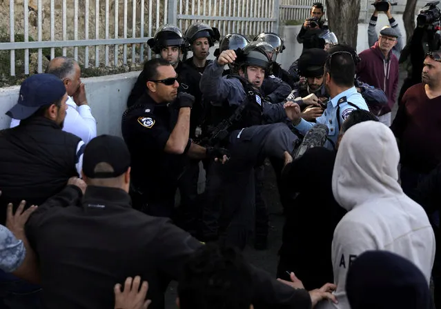Israeli police officers scuffle with Palestinian protesters after Friday prayers on a street outside the East Jerusalem neighbourhood of Issawiya, February 2, 2018. (Photo by Ammar Awad/Reuters)
