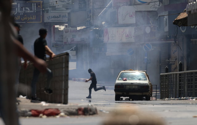 A Palestinian man runs to seek cover during an Israeli military operation in the West Bank city of Nablus, 10 June 2025. According to the Palestinian Ministry of Health, at least two Palestinians were killed and over 60 others were injured in an ongoing Israeli operation in Nablus. (Photo by Alaa Badarneh/EPA)