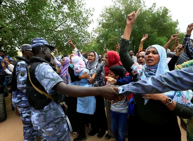 Sudanese chant slogans outside a court during a new trial against ousted President Omar al-Bashir and some of his former allies over the 1989 military coup that brought the autocrat to power in 1989, outside a courthouse in Khartoum, Sudan on September 15, 2020. (Photo by Mohamed Nureldin Abdallah/Reuters)