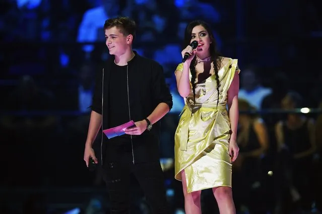 Charli XCX and Martin Garrix present on stage during the MTV EMA's 2015 at the Mediolanum Forum on October 25, 2015 in Milan, Italy. (Photo by Brian Rasic/Getty Images for MTV)