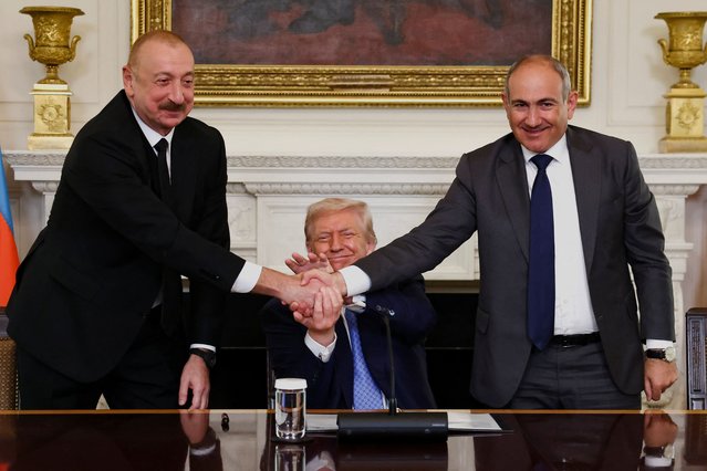 U.S. President Donald Trump holds the hands of Azerbaijan's President Ilham Aliyev and Armenia's Prime Minister Nikol Pashinyan as they shake hands between each other during a trilateral signing event, at the White House, in Washington, D.C., on August 8, 2025. (Photo by Kevin Lamarque/Reuters)