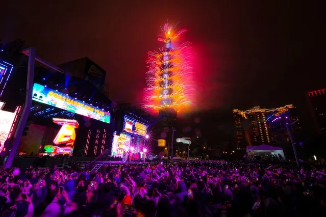 Fireworks and light effects illuminate the night sky from the Taipei 101 skyscraper during New Year's celebrations in Taipei, Taiwan, 01 January 2022. (Photo by Ritchie B. Tongo/EPA/EFE)