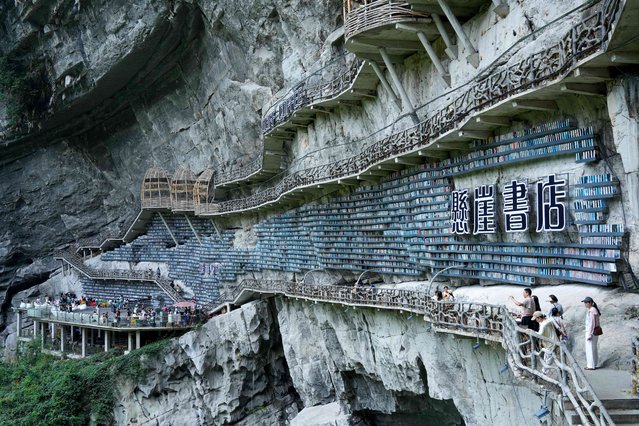 A view of the Cliff Bookstore within the Cotton Sinkhole on August 9, 2025 in Hechi, Guangxi Zhuang Autonomous Region of China. The bookstore is built adjacent to the cliff, blending seamlessly with the mountain. (Photo by Long Tao/VCG via Getty Images)