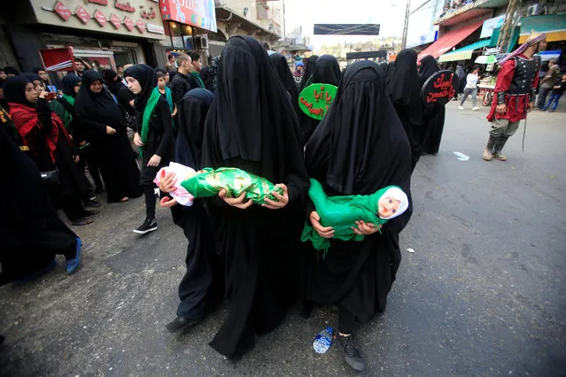 Muslim Shi'ite women march during a re-enactment of the battle of Kerbala during a mourning process, one day before the Shi'ites will mark the day of Ashura, in Nabatiyeh, Lebanon October 11, 2016. (Photo by Ali Hashisho/Reuters)