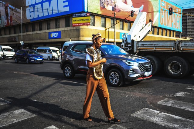 A pedestrian wearing Zulu traditional attire walks in the Pretoria Central Business District (CBD), South Africa on September 23, 2025, ahead of the national heritage day. (Photo by Phill Magakoe/AFP Photo)