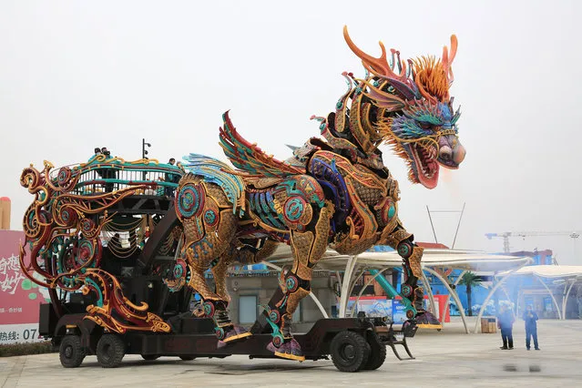 A robotic installation of kylin (or qilin), animal from Chinese myth, at a square attracts people on Chinese New Year on February 1, 2022 in Xiangyang, Hubei Province of China. (Photo by Li Fuhua/VCG via Getty Images)