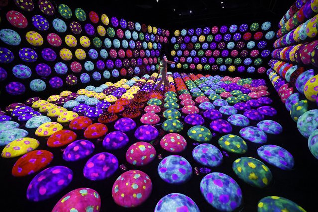 A staff member steps on the Athletics Forest artwork during a preview of the new museum “teamLab Biovortex Kyoto” in Kyoto, western Japan, 24 September 2025. Art collective teamLab will open to the public its new permanent art museum, teamLab Biovortex Kyoto, on 07 October 2025. The facility will be teamLab's largest museum in Japan, featuring more than 50 artworks. (Photo by Franck Robichon/EPA)