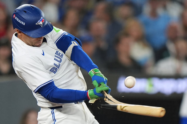 Toronto Blue Jays' George Springer breaks his bat on pop flyout to foul territory during the first inning of Game 6 of baseball's American League Championship Series against the Seattle Mariners in Toronto, Sunday, October 19, 2025. (Photo by Frank Gunn/The Canadian Press via AP Photo)