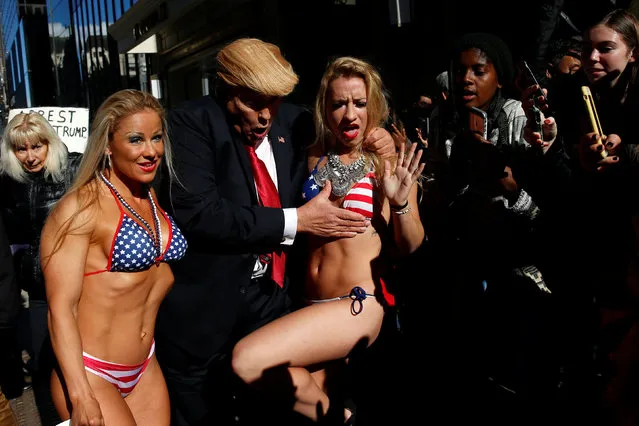 A man dressed as U.S. Republican candidate Donald Trump gropes at bikini clad women as part of a performance piece by British author and artist Alison Jackson outside Trump Tower in New York, U.S., October 25, 2016. (Photo by Shannon Stapleton/Reuters)
