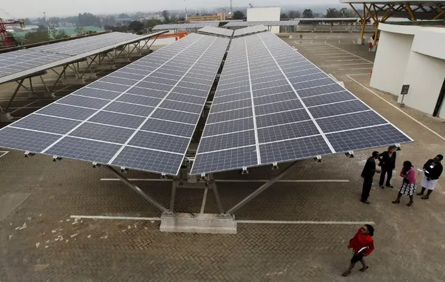 Delegates are pictured during the launch event of a solar carport at the Garden City shopping mall in Kenya's capital Nairobi, September 15, 2015. The Africa's largest solar carport with 3,300 solar panels will generate 1256 MWh annually and cut carbon emission by around 745 tonnes per year, according to Solarcentury and Solar Africa. (Photo by Thomas Mukoya/Reuters)