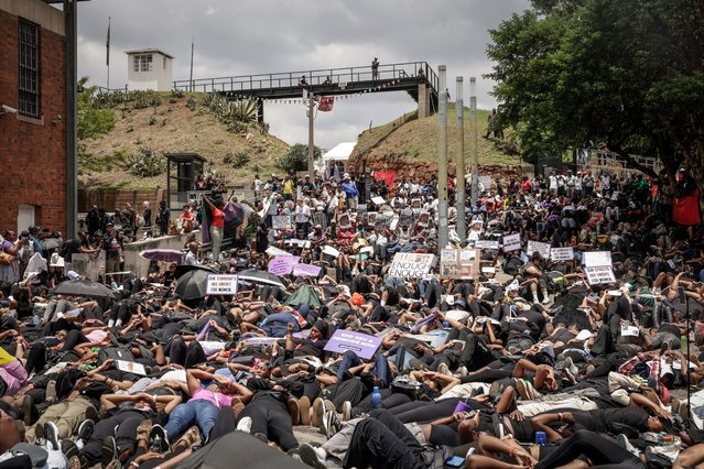 Protesters lie on the ground during the Women's Nationwide Shutdown at Constitution Hill in Johannesburg on November 21, 2025, ahead of the G20 leaders' Summit. Women for Change calls on the community across South Africa to refrain from all paid and unpaid work in workplaces, universities, and homes, and to spend no money for the entire day to demonstrate the economic and social impact of their absence, and demand that gender-based violence and femicide be declared a national disaster. (Photo by Gianluigi Guercia/AFP Photo)