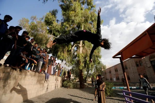 A boy performs acrobatics at the yard of an orphanage in Sanaa, Yemen May 30, 2018. (Photo by Khaled Abdullah/Reuters)