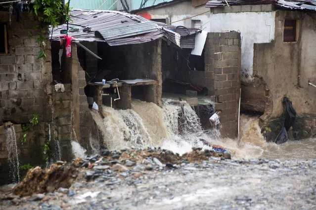 Water gushes from a destroyed house in Santo Domingo as it causes some to collapse on August 23, 2020 as Tropical Storm Laura batters the region. Tropical Storm Laura hammered Hispaniola island with heavy rain killing at least three people in the Dominican Republic and five in Haiti, and was set to become a hurricane on Tuesday. (Photo by Erika Santelices/AFP Photo)