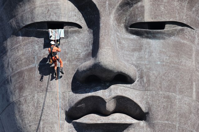 Firefighters descend using ropes during a rescue drill at Ushiku Daibutsu on December 10, 2025 in Ushiku, Ibaraki, Japan. (Photo by The Asahi Shimbun via Getty Images)