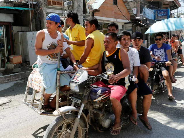 Workers who were cut off from their jobs due to the temporary closure of the holiday island Boracay, ride on a tricycle in the Philippines April 25, 2018. (Photo by Erik De Castro/Reuters)