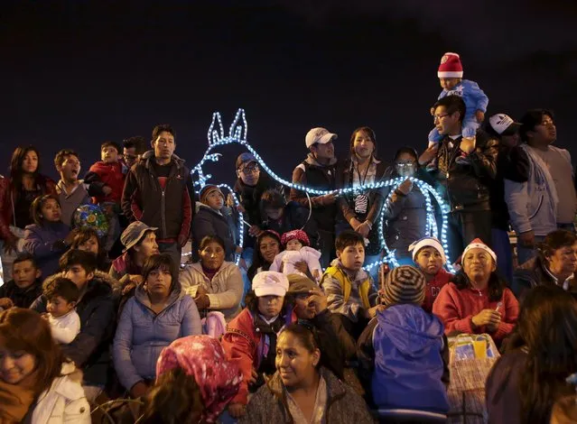 Residents of La Paz city attend a Christmas parade in La Paz, Bolivia, December 12, 2015. (Photo by David Mercado/Reuters)