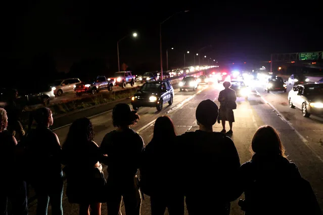 Demonstrators form a line to stop traffic on Interstate 580 during a demonstration following the election of Donald Trump as President of the United States in Oakland, California, U.S. November 10, 2016. (Photo by Stephen Lam/Reuters)