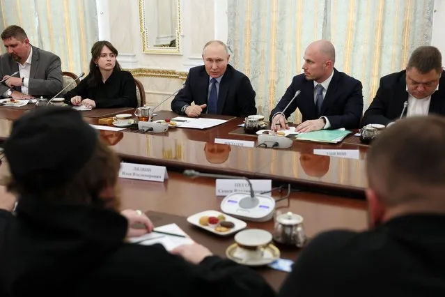Russian President Vladimir Putin, center, speaks during a meeting with Russian war correspondents who cover a special military operation, at the Kremlin in Moscow, Russia, Tuesday, June 13, 2023. (Photo by Gavriil Grigorov, Sputnik, Kremlin Pool Photo via AP Photo)