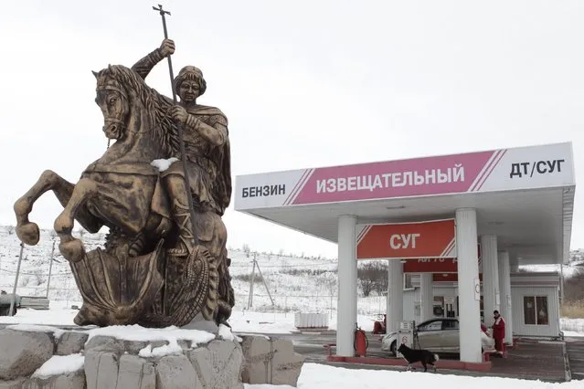 A statue of St. George slaying a dragon is seen outside the fuel station in the village of Izveshchatelnyy, south of Stavropol, Russia January 12, 2015. (Photo by Eduard Korniyenko/Reuters)